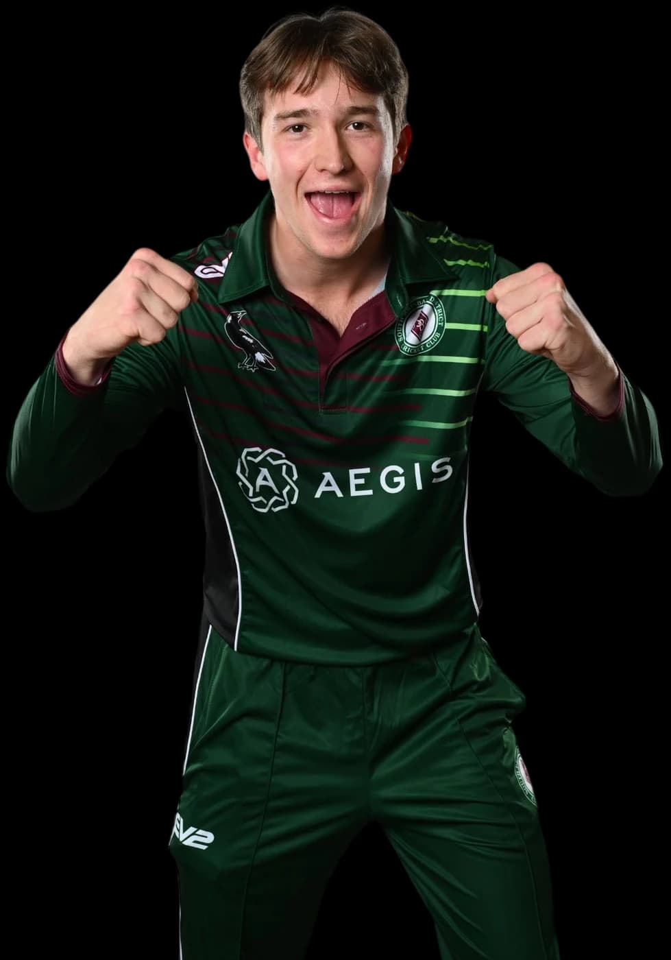 A Magpies player pointing to the club badge on their shirt